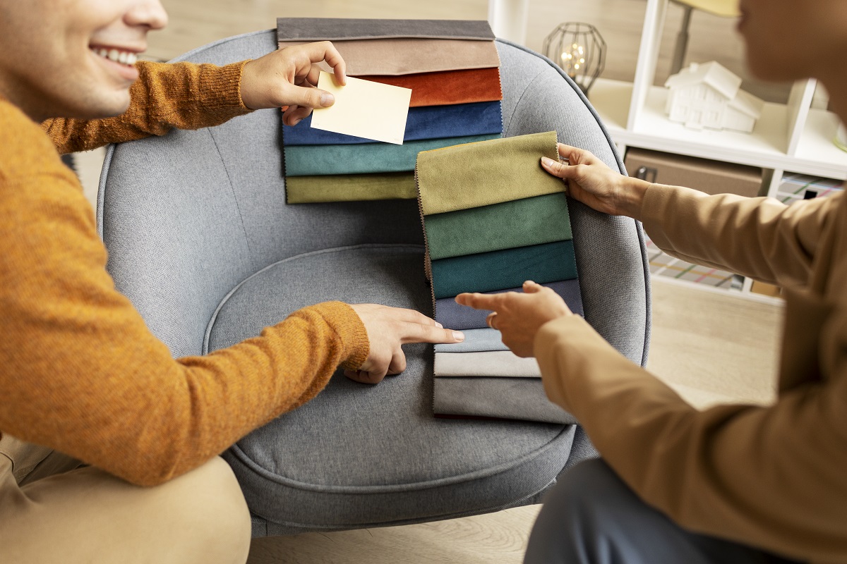 woman looking at fabric samples, choosing material for her seat to be reupholstered
