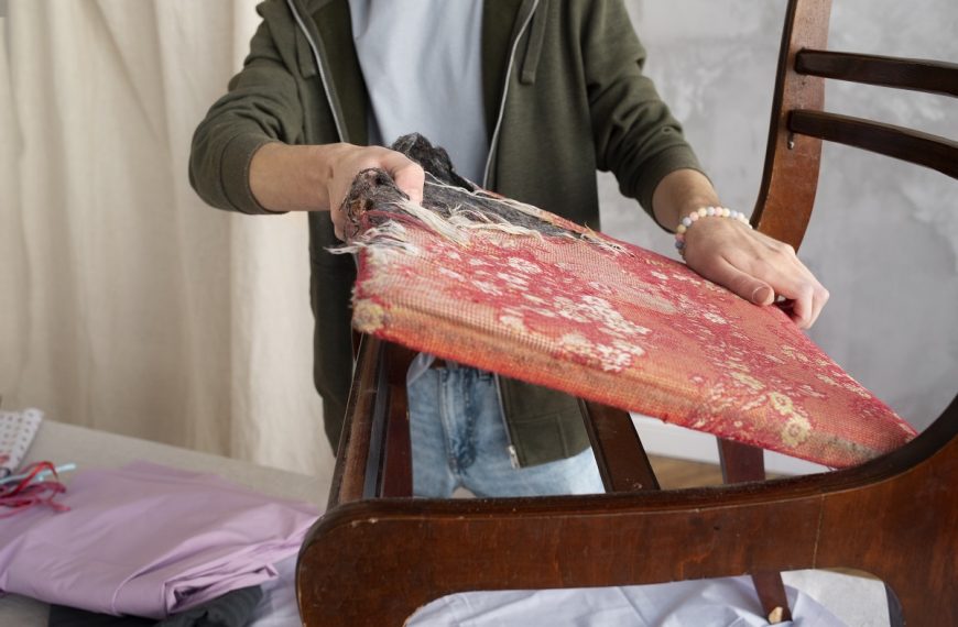 woman reupholstering a chair